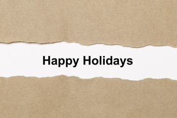 happy holidays text on paper. Word happy holidays on torn paper. Concept Image.
