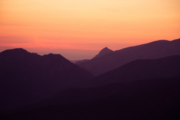 A beautiful, colorful sunrise sceney in mountains in purlpe tone. Abstract, minimalist landscape in Tatra mountains. Color gradients. Tatra mountains in Slovakia, Europe.