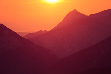 A beautiful, colorful sunrise sceney in mountains in purlpe tone. Abstract, minimalist landscape in Tatra mountains. Color gradients. Tatra mountains in Slovakia, Europe.