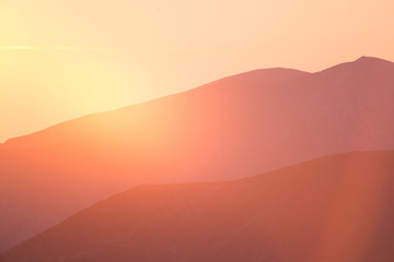 A beautiful, colorful sunrise sceney in mountains in purlpe tone. Abstract, minimalist landscape in Tatra mountains. Color gradients. Tatra mountains in Slovakia, Europe.