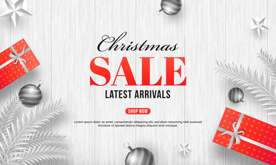 Christmas sale with best offers, top view of decorative gift boxes, stars and baubles on white wooden texture background.