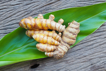 Fresh turmeric on old wooden table. herbal