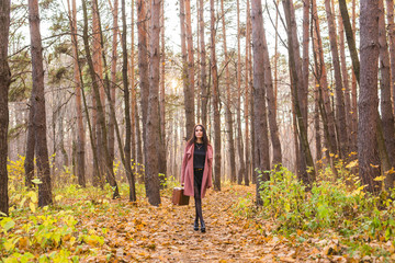 Portrait of beautiful young woman walking outdoors in autumn.