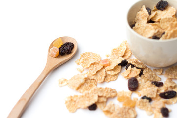 whole grain cereal flakes which mixed berry fruit and raisins for breakfast isolaed on white background