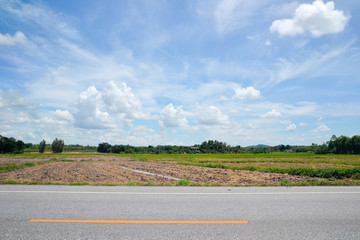 road with field and blue sky