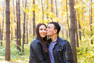 Cute couple outdoors in fall. Young man and woman in autumn nature