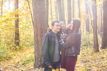 Parenthood, fall and people concept - young family happy in autumn park