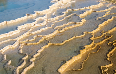 Yellow and white layers of travertine in Mammoth Hot Springs create an abstract image