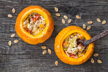 pumpkin baked stuffed with vegetables, tomatoes, pepper, chicken, cereals with seeds