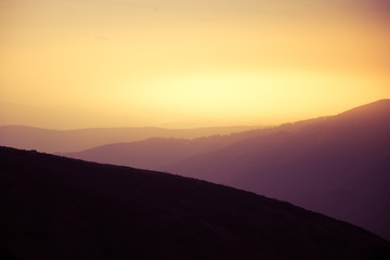 Obraz premium A beautiful, abstract, colorful sunset scenery in mountains in warm tones. Mountain landscape in colors. Tatry mountains in Slovakia, Europe.