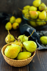 Fresh garden pears on dark wooden table