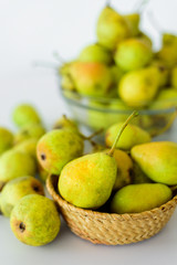Fresh pears on white table