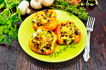 Pepper stuffed with mushrooms and couscous in green plate