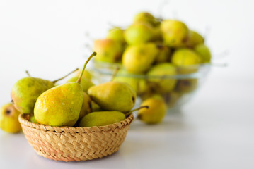 Fresh pears on white table