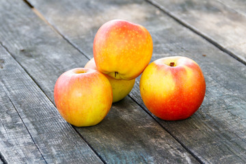 Fresh ripe apples on rustic wooden table