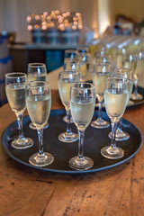 Trays of filled glasses of champagne ready for a celebratory toast