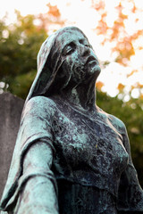 A magnificent statue of a woman in a Parisian cemetery
