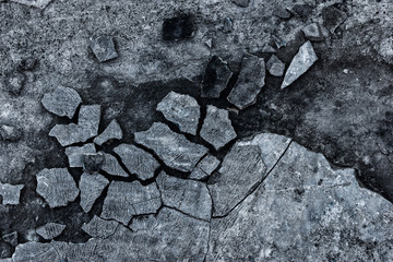 Dark gray grunge background of broken concrete