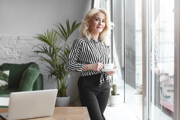 Picture of mature elegant Caucsian senior elderly female with blonde hair and slim fit body...
