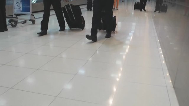 Traveller passenger walking with suitcase at airport
