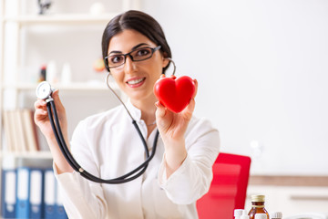 Young doctor in heart care concept