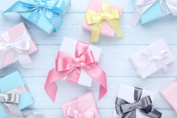 Colorful gift boxes with ribbon on wooden table