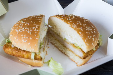 Hamburger cut into two. Hamburger in the box.