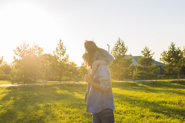 Fototapeta premium Fatherhood, family and children concept - Father and daughter having fun and playing in nature.