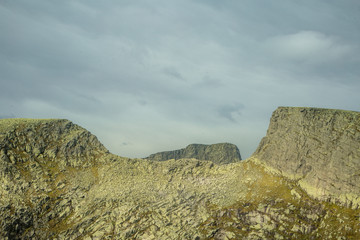 A beautiful autumn landscape in Folgefonna National Park in Norway during a hike in windy, rainy weather. Mountains in Scandinavia. Autumn scenery in wilderness.