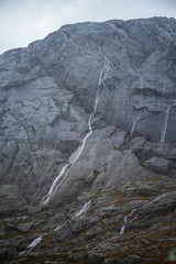 A beautiful autumn landscape in Folgefonna National Park in Norway during a hike in windy, rainy weather. Mountains in Scandinavia. Autumn scenery in wilderness.