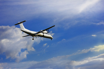 Fototapeta na wymiar flying plane in blue clear sky close-up
