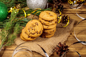 Chocolate chip cookies with Christmas decoration on wooden table