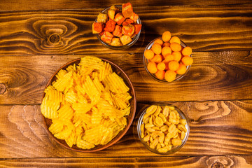 Different snacks for beer on wooden table. Top view