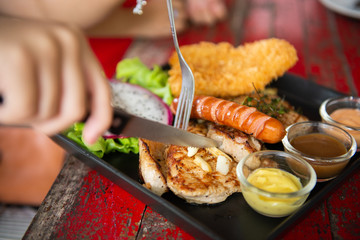 top view of mix steak with and fresh green herb salad and dragon fruit on vintage wooden table