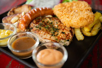 top view of mix steak with and fresh green herb salad and dragon fruit on vintage wooden table