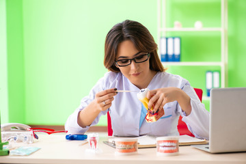 Woman dentist working on teeth implant