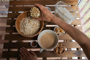 Preparation of granola, cooking process, healthy breakfast idea, vegan, dieting and detox concept.