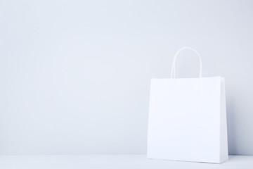 Paper shopping bag on grey background