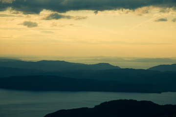 A magnificent sunset scenery over the fjords in Norway. A beautiful autumn landscape in Folgefonna national park. Dramatic sky and mountains.