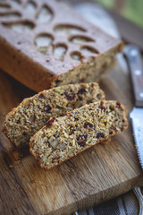 gluten free baked bread in baker hands on wooden background