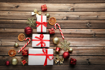 Fir-tree made from gift boxes and christmas decorations on wooden table