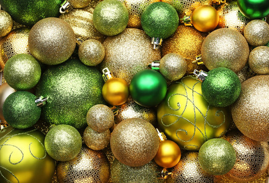 Golden and green christmas baubles background