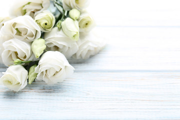 Bouquet of eustoma flowers on wooden table