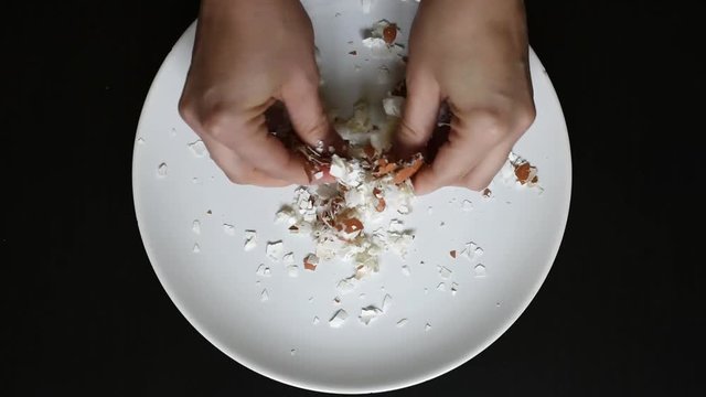 Grind the eggshell with your hands for further grinding and grinding into small crumbs or powder for natural scrub 