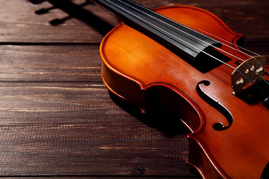 Violin on brown wooden table