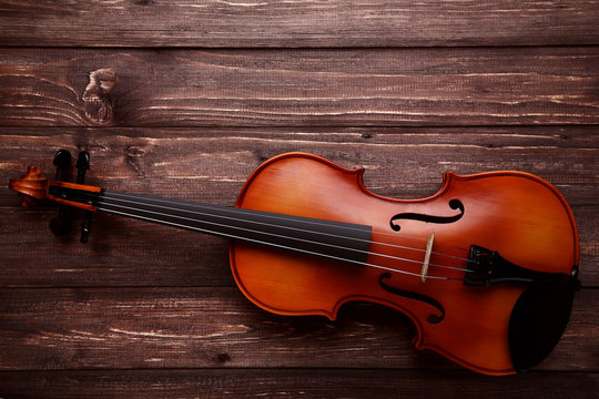 Violin on brown wooden table