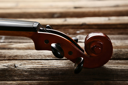 Violin head on brown wooden table