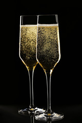 Champagne glasses on black background