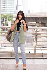 Fototapeta premium Beautiful young teen using headphones and listening to music at shopping center