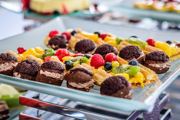 Assorted desserts puffs tarts puddings cakes creme brulee